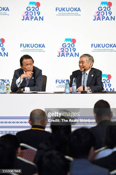 Japanese Finance Minister Taro Aso and Bank of Japan governor Haruhiko Kuroda attend a press conference following the G20 Finance Ministers and...
