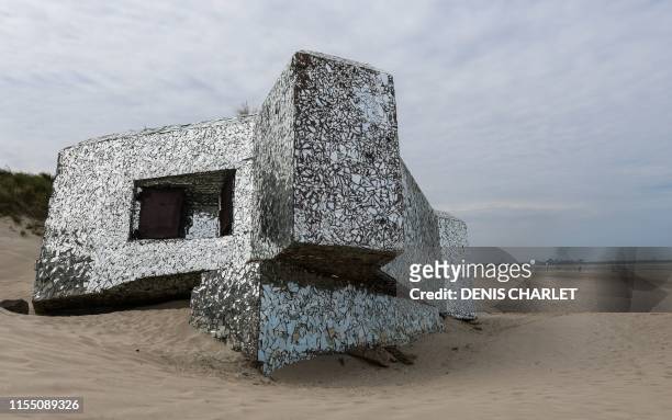 This picture taken on July 11, 2019 on the beach of the northern France coastal village of Leffrinckoucke near Dunkirk shows a Blockhaus of the Worl...