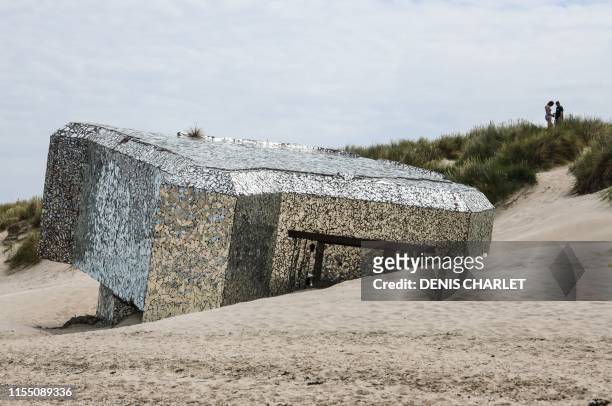 This picture taken on July 11, 2019 on the beach of the northern France coastal village of Leffrinckoucke near Dunkirk shows a Blockhaus of the Worl...