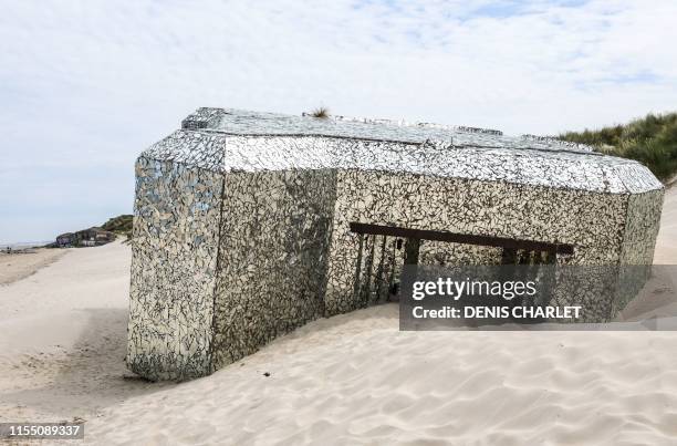 This picture taken on July 11, 2019 on the beach of the northern France coastal village of Leffrinckoucke near Dunkirk shows a Blockhaus of the Worl...