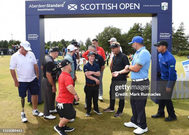 Soren Kjeldsen of Denmark and Ryan Fox of New Zealand speak with the EDGA professional golfers at the putting green during Day One of the Aberdeen...
