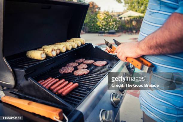 close up of man grilling - burger grill stock pictures, royalty-free photos & images