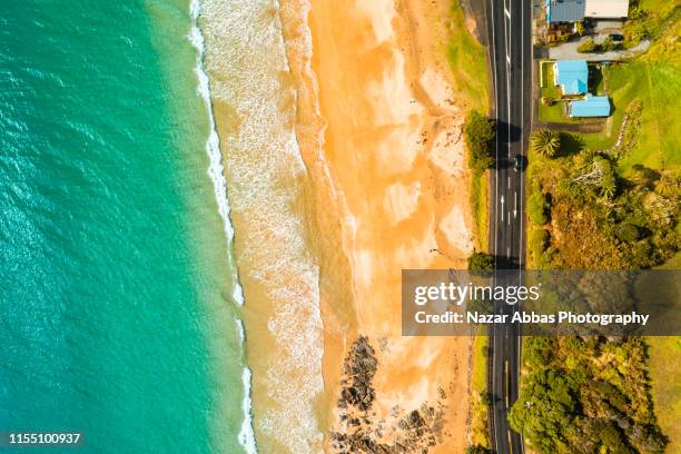 aerial view of beach, road and houses. - new zealand beach house stock pictures, royalty-free photos & images