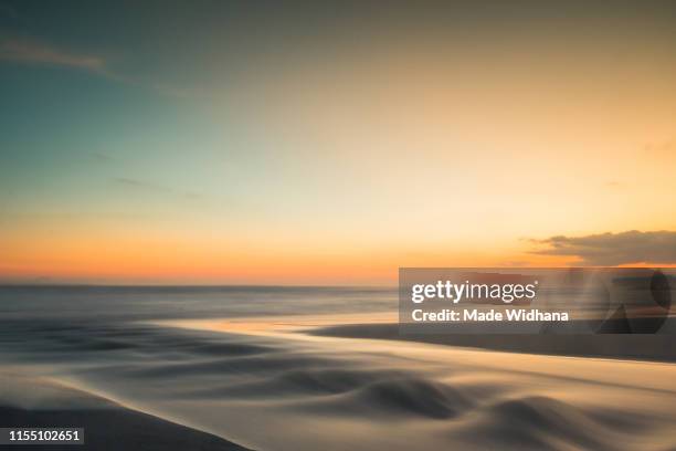 long exposure after sunset at the beach - made widhana stock pictures, royalty-free photos & images