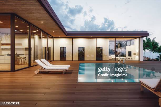 modernt lyxhus med privat pool i skymningen - utedäck bildbanksfoton och bilder