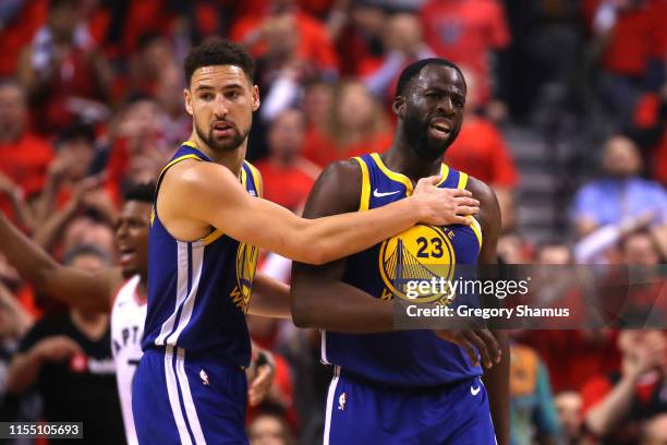 Klay Thompson and Draymond Green of the Golden State Warriors react after a foul call against the Toronto Raptors in the first half during Game Five...