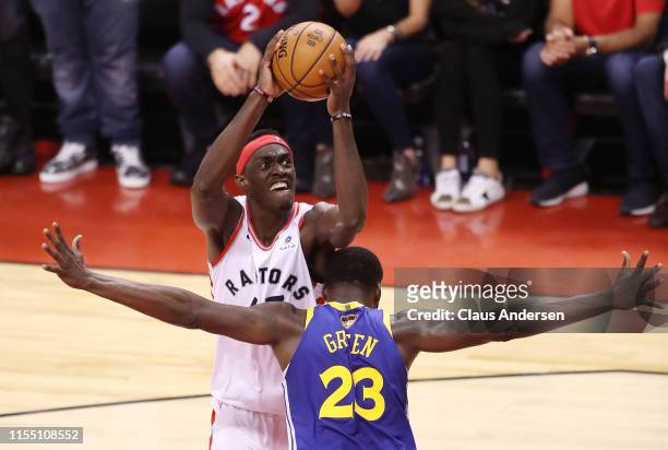 Pascal Siakam of the Toronto Raptors attempts a shot against Draymond Green of the Golden State Warriors in the first half during Game Five of the...