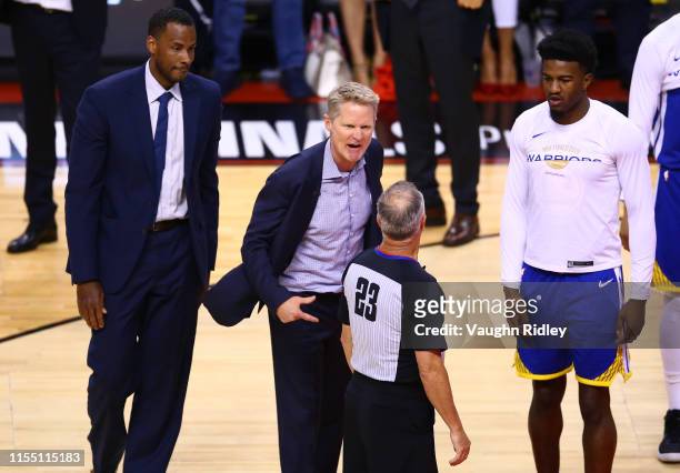 Head coach Steve Kerr of the Golden State Warriors complains to referee Jason Phillips against the Toronto Raptors in the second half during Game...
