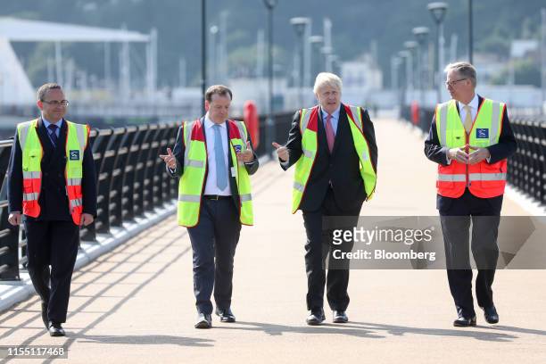 Boris Johnson, former U.K. Foreign secretary, second right, walks with Charlie Elphicke, U.K. Lawmaker, seond left, and Doug Bannister, chief...