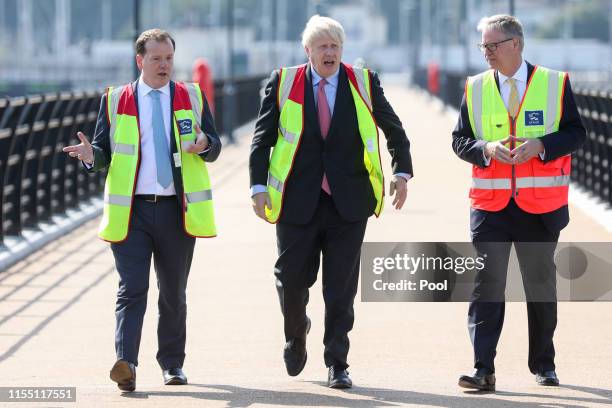 Boris Johnson walks with Charlie Elphicke, U.K. Lawmaker and Doug Bannister, chief executive officer of Port of Dover Ltd. , during a visit to the...