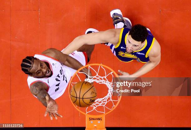 Kawhi Leonard of the Toronto Raptors attempts a shot against Klay Thompson of the Golden State Warriors during Game Five of the 2019 NBA Finals at...