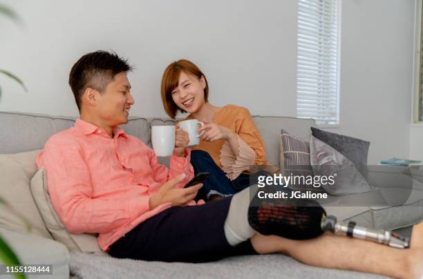 young couple relaxing at home - disability collection stock pictures, royalty-free photos & images