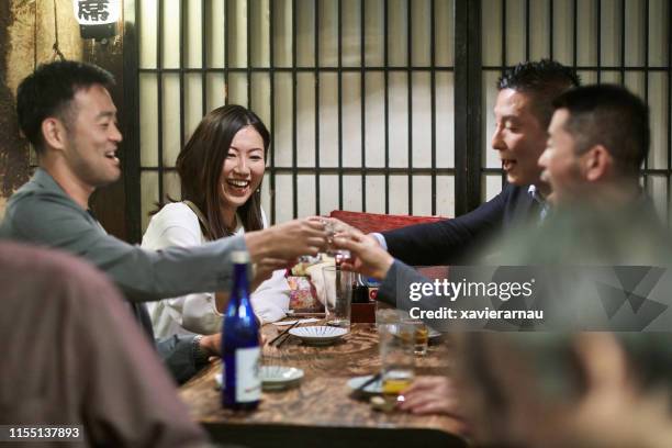 group of japanese coworkers celebrating at tokyo restaurant - sushi restaurant stock pictures, royalty-free photos & images