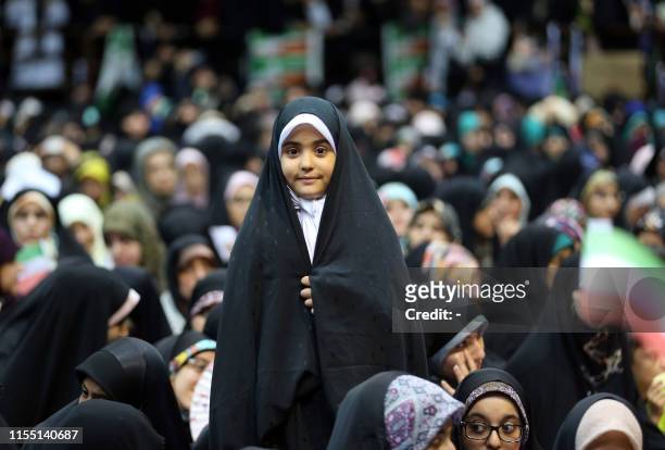 An Iranian girl attends a rally in support of wearing headscarves at the Sahhid Shiroudi Stadium in Tehran, on July 11, 2019. - Under Islamic law in...