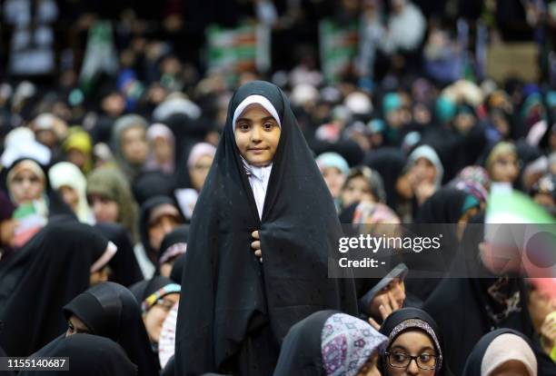 An Iranian girl attends a rally in support of wearing headscarves at the Sahhid Shiroudi Stadium in Tehran, on July 11, 2019. - Under Islamic law in...