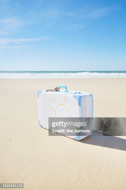 suitcase with painted sun on the beach (diy project) - vintage luggage stock pictures, royalty-free photos & images