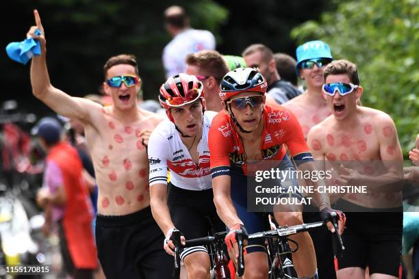 Belgium's Dylan Teuns cycles followed by Italy's Giulio Ciccone as fans run beside them before the finish line of the sixth stage of the 106th...
