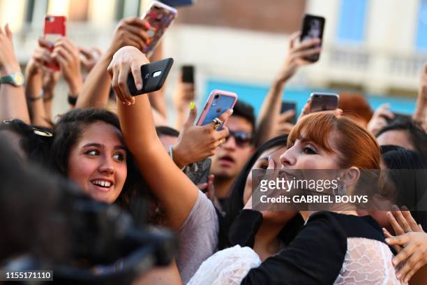 Spanish actress Najwa Nimri blows a kiss as she poses with fans during a photocall for the presentation of the third season of the Spanish TV show...