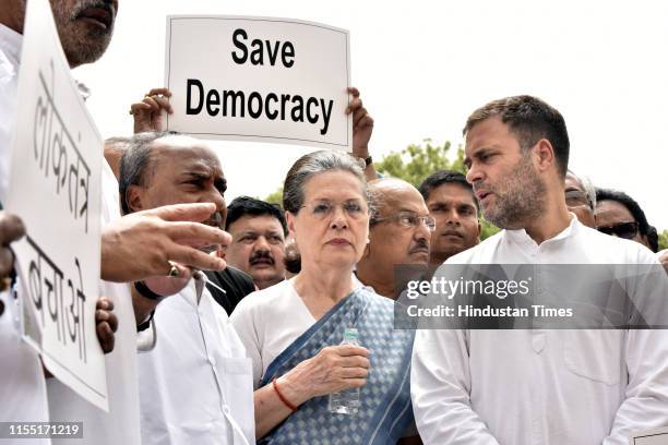 Congress MP Rahul Gandhi speaks to UPA Chairperson Sonia Gandhi during their 'Save Democracy' protest over Karnataka and Goa issues, in front of the...