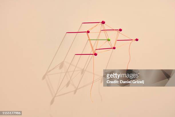 Map pins tangled with a string
