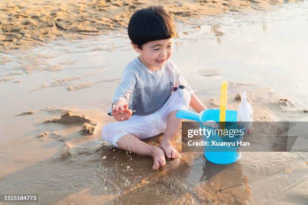 little girl playing at beach - who could play young han solo stock pictures, royalty-free photos & images