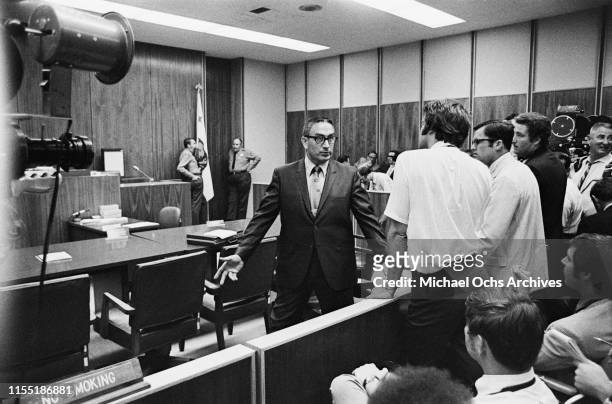 Man talks to reporters attending a hearing regarding the murder of music teacher Gary Hinman by members of the Manson Family at the Santa Monica...