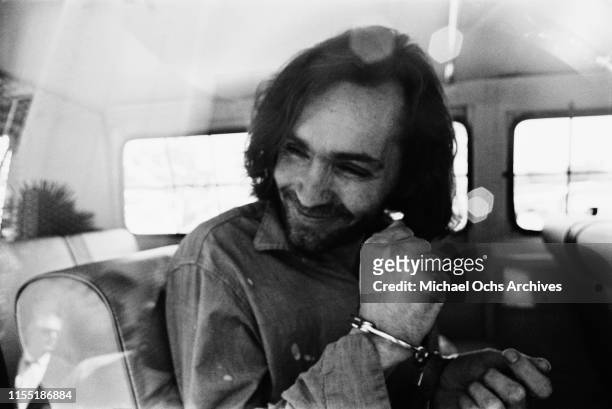 American criminal and cult leader Charles Manson traveling on a police van to the Santa Monica Courthouse to appear in court for a hearing regarding...