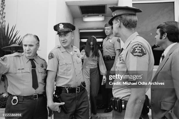 American murderer and member of the Manson Family Susan Atkins is escorted by Los Angeles County sheriffs to the Santa Monica Courthouse to appear in...