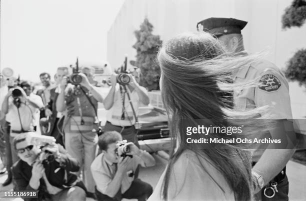 American murderer and member of the Manson Family Susan Atkins is escorted by Los Angeles County sheriffs to the Santa Monica Courthouse to appear in...