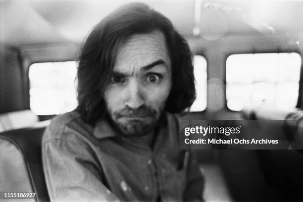 American criminal and cult leader Charles Manson traveling on a police van to the Santa Monica Courthouse to appear in court for a hearing regarding...