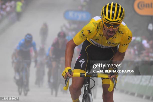 France's Julian Alaphilippe, wearing the overall leader's yellow jersey, and cyclists ride in the last kilometre of the sixth stage of the 106th...