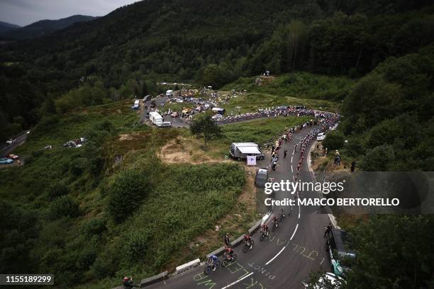 The pack rides on a panoramic road during the sixth stage of the 106th edition of the Tour de France cycling race between Mulhouse and La Planche des...