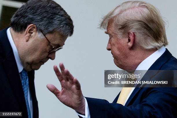 Attorney General William Barr and US President Donald Trump leave after delivering remarks on citizenship and the census in the Rose Garden at the...