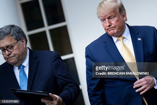 President Donald Trump and US Attorney General William Barr arrive to deliver remarks on citizenship and the census in the Rose Garden at the White...