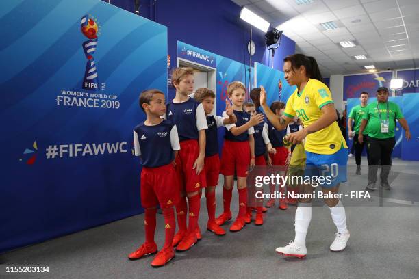 Raquel Fernandes of Brazil shakes hands with mascots in the tunnel ahead of the 2019 FIFA Women's World Cup France group C match between Brazil and...