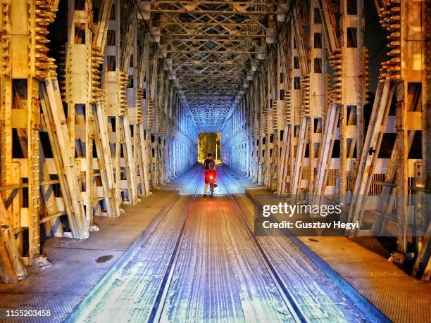 night bike ride on the bridge - budapest nightlife stock pictures, royalty-free photos & images