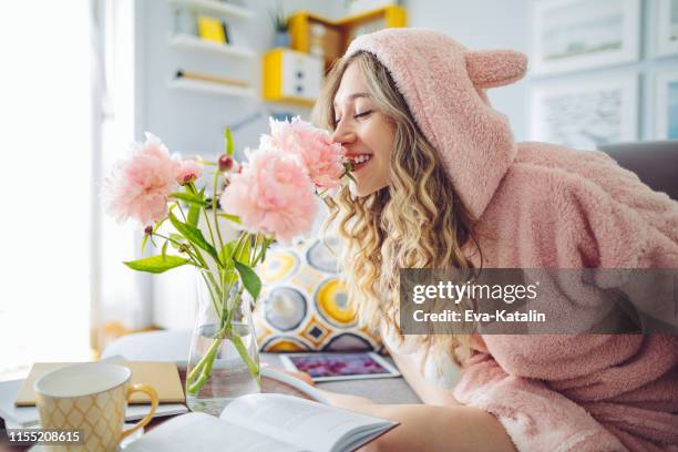young woman at home - bear suit stock pictures, royalty-free photos & images