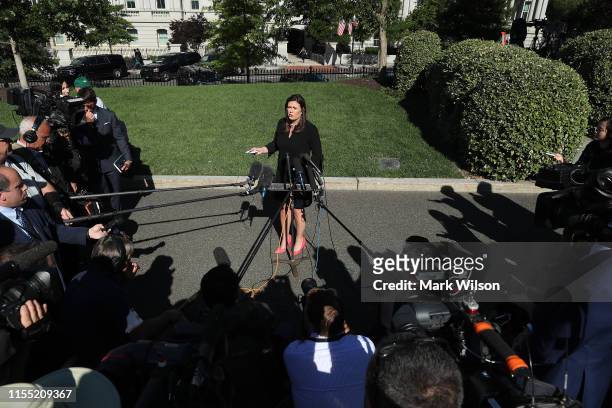 White House Press Secretary Sarah Huckabee Sanders talks to reporters after an interview with FOX News outside the West Wing, June 11, 2019 in...