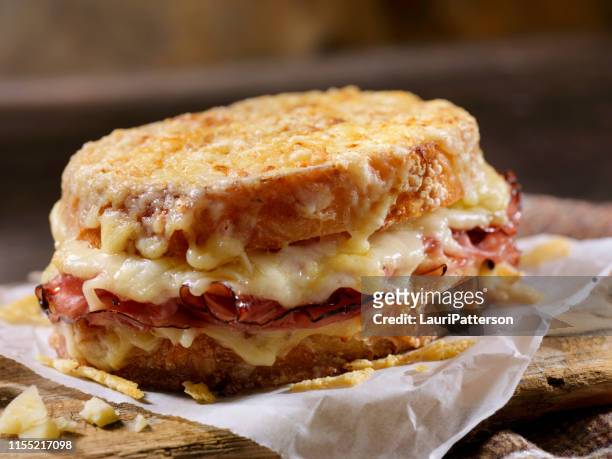 croque monsieur, grilled cheese sandwich with black forest ham, gruyere and bechamel sauce - melted cheese stock pictures, royalty-free photos & images