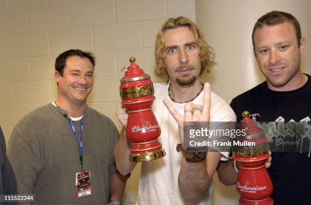 Chris Hendley of the Arena at Gwinnett Center present custom beer steins to Chad Kroeger and Mike Kroeger of Nickelback