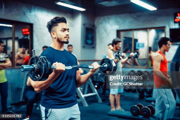 asian adult man working out at the gym - group of people flexing biceps stock pictures, royalty-free photos & images