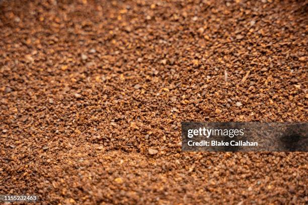 background of ground coffee beans - ground coffee stock pictures, royalty-free photos & images