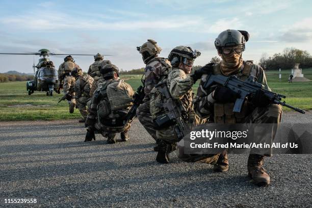 French, british and american paratroopers training together in south of France for the Falcon Amarante mission with an helicopter in the backgrounp,...