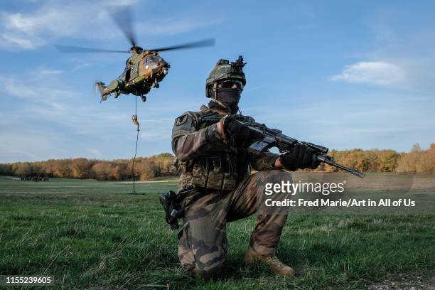 French, british and american paratroopers training together in south of France for the Falcon Amarante mission with an helicopter flying in the sky,...