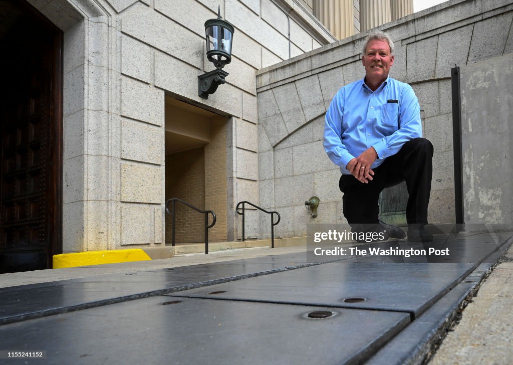 Tim Edwards, facility manager for the National Archives, with the flood control system that kept Mondays' storm flooding out of his building in Washington, DC.