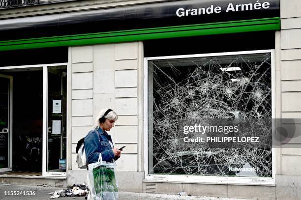 This picture taken on July 12 shows a broken window on the Avenue de la Grande Armee, near the Arc de Triomphe in Paris where Algerian supporters...