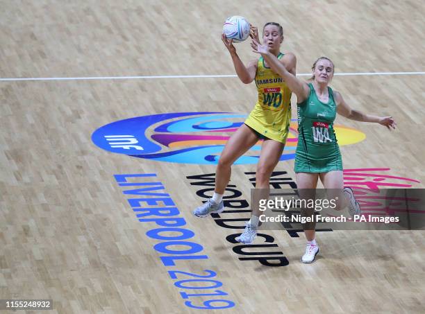 Australia's Jamie-Lee Price and Northern Ireland's Lisa McCaffrey battle for the ball during the Netball World Cup match at the M&S Bank Arena,...