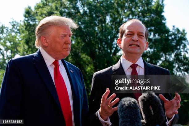 President Donald Trump listens to US Labor Secretary Alexander Acosta as he speaks to the media early July 12, 2019 at the White House in Washington,...