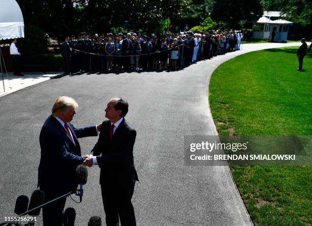 President Donald Trump shakes hands with US Labor Secretary Alexander Acosta during a media address early July 12, 2019 at the White House in...