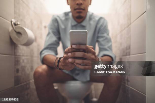 young man at home - men taking a dump stock pictures, royalty-free photos & images